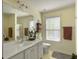 Bright bathroom with a large mirror, vanity, and natural light from the window at 139 Pointer Dr, Goose Creek, SC 29445
