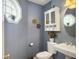 Stylish half bathroom with pedestal sink, decorative mirror and a window at 139 Pointer Dr, Goose Creek, SC 29445