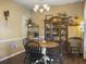 Cozy dining area showcasing a round wooden table, black spindle chairs, and an overhead chandelier for warm lighting at 139 Pointer Dr, Goose Creek, SC 29445