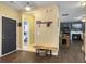 Inviting entryway with dark wood floors, a wooden bench and coat hooks, leading to a living room with a cozy fireplace at 139 Pointer Dr, Goose Creek, SC 29445