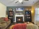 Comfortable living room features a fireplace, built-in bookshelves, and a cozy seating area with a view of a flat screen TV at 139 Pointer Dr, Goose Creek, SC 29445