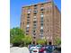 Exterior of a tall brick building and parking lot with several cars parked at the location at 14 Lockwood Dr # 2E, Charleston, SC 29401
