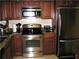 The kitchen offers stainless steel appliances and wooden cabinets with granite countertops at 14 Lockwood Dr # 2E, Charleston, SC 29401