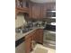 Kitchen with stainless steel appliances, granite countertops, and wooden cabinets at 14 Lockwood Dr # 2E, Charleston, SC 29401