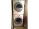 Efficient laundry area featuring a stacked washer and dryer, maximizing space and convenience at 14 Lockwood Dr # 2E, Charleston, SC 29401