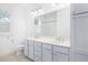 Bathroom featuring a double sink vanity, large mirror, and blue accents at 1470 Eutaw Battalion Dr, Charleston, SC 29412