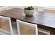 Close-up of a wooden dining table with cane chairs and moss decorative bowl at 1470 Eutaw Battalion Dr, Charleston, SC 29412