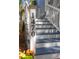 Close-up of the house number '1470' on the staircase post with vibrant flowers, showing great curb appeal at 1470 Eutaw Battalion Dr, Charleston, SC 29412