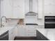 Bright kitchen with white cabinets, a farmhouse sink, stainless hood and black gas range at 1470 Eutaw Battalion Dr, Charleston, SC 29412