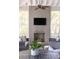 This screened porch offers a cozy fireplace and television for outdoor entertaining at 1470 Eutaw Battalion Dr, Charleston, SC 29412