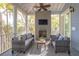Screened porch featuring grey seating, a fireplace and a ceiling fan at 1470 Eutaw Battalion Dr, Charleston, SC 29412