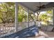 Inviting porch featuring wicker seating, a ceiling fan, and peaceful views of mature trees and a quaint neighborhood at 1470 Eutaw Battalion Dr, Charleston, SC 29412