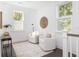 Bright sitting area with two armchairs, dark floors, and lots of natural light at 1470 Eutaw Battalion Dr, Charleston, SC 29412