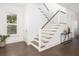 Light-filled foyer with a staircase featuring hardwood steps and white risers at 1470 Eutaw Battalion Dr, Charleston, SC 29412