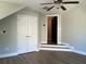 Neutral bedroom featuring modern ceiling fan, hardwood floors, an entrance, and double closets at 1496 Cypress Pointe Dr, Mount Pleasant, SC 29466