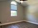 Bedroom featuring a high arched window with blinds and hardwood flooring at 1496 Cypress Pointe Dr, Mount Pleasant, SC 29466