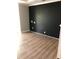 This bedroom has a feature wall painted black and hard wood floors at 1496 Cypress Pointe Dr, Mount Pleasant, SC 29466