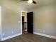 Bedroom with hardwood floors, neutral walls, and a black door leading to the hallway at 1496 Cypress Pointe Dr, Mount Pleasant, SC 29466