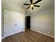Bedroom featuring hardwood flooring, wainscoting, modern ceiling fan and double closets at 1496 Cypress Pointe Dr, Mount Pleasant, SC 29466