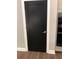 This interior door is a sleek black, providing an elegant contrast to the white trim at 1496 Cypress Pointe Dr, Mount Pleasant, SC 29466
