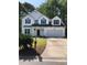 Charming two-story home featuring black shutters, an attached two-car garage, and a well-manicured lawn at 1496 Cypress Pointe Dr, Mount Pleasant, SC 29466