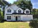 Charming two-story home featuring black shutters, an attached two-car garage, and a well-manicured lawn at 1496 Cypress Pointe Dr, Mount Pleasant, SC 29466