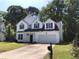 Charming two-story home featuring black shutters, an attached two-car garage, and a well-manicured lawn at 1496 Cypress Pointe Dr, Mount Pleasant, SC 29466