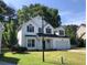 Charming two-story home featuring black shutters, an attached two-car garage, and a well-manicured lawn at 1496 Cypress Pointe Dr, Mount Pleasant, SC 29466