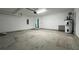 Large garage featuring white walls, concrete flooring, and a water heater at 1496 Cypress Pointe Dr, Mount Pleasant, SC 29466