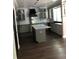 Bright kitchen with an island, white cabinets, granite countertops, stainless steel appliances, and hardwood floors at 1496 Cypress Pointe Dr, Mount Pleasant, SC 29466