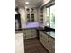 Kitchen showcasing gray cabinets and a black countertop at 1496 Cypress Pointe Dr, Mount Pleasant, SC 29466