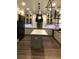 Bright kitchen with an island, white cabinets, granite countertops, stainless steel appliances, and hardwood floors at 1496 Cypress Pointe Dr, Mount Pleasant, SC 29466