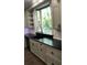 Bright kitchen with white cabinets, black countertops, stainless steel appliances, and hardwood floors at 1496 Cypress Pointe Dr, Mount Pleasant, SC 29466