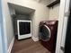 Modern laundry room with updated washer and dryer and built-in shelving at 1496 Cypress Pointe Dr, Mount Pleasant, SC 29466