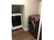 This is a view of a laundry room with a white dryer and red washing machine at 1496 Cypress Pointe Dr, Mount Pleasant, SC 29466