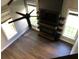 Living room with a ceiling fan, fireplace, TV, shelves, and hardwood floors at 1496 Cypress Pointe Dr, Mount Pleasant, SC 29466