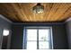 Neutral room featuring hardwood floors, trim, a ceiling fan, a window, and an interior door at 1496 Cypress Pointe Dr, Mount Pleasant, SC 29466