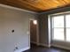 Neutral room featuring hardwood floors, trim, a ceiling fan, a window, and an interior door at 1496 Cypress Pointe Dr, Mount Pleasant, SC 29466
