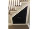 Staircase with wooden steps, black iron railing, and storage under stairs at 1496 Cypress Pointe Dr, Mount Pleasant, SC 29466