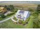 A high angle view of a two-story home with solar panels, lush greenery, and a curved driveway at 1500 Bower Ln, Johns Island, SC 29455