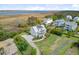 Stunning aerial shot of a charming coastal home with solar panels, nestled in a lush landscape at 1500 Bower Ln, Johns Island, SC 29455