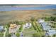 Aerial view of a waterfront neighborhood with homes, landscaping, and a marshy area in the background at 1500 Bower Ln, Johns Island, SC 29455