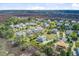 An overhead view shows a luxury real estate neighborhood filled with landscaped homes and pond at 1500 Bower Ln, Johns Island, SC 29455