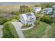 A high angle view of a two-story home featuring a metal roof, solar panels, driveway, and manicured landscaping at 1500 Bower Ln, Johns Island, SC 29455