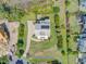 Overhead view of a home with solar panels on the roof, an expansive yard, and a long driveway at 1500 Bower Ln, Johns Island, SC 29455