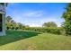 Sprawling green backyard with a wrought iron fence bordering the property's edge at 1500 Bower Ln, Johns Island, SC 29455