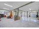 Unfinished basement space with multiple garage doors, white walls, exposed support beams, and storage at 1500 Bower Ln, Johns Island, SC 29455