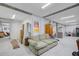 Partially finished basement with a couch, boxes, exposed beams, and white walls at 1500 Bower Ln, Johns Island, SC 29455