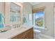Bathroom featuring a wood vanity, framed mirror, toilet and window with a view at 1500 Bower Ln, Johns Island, SC 29455