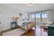 Bedroom featuring hardwood floors, a view of the waterfront, a quilt, and white trim at 1500 Bower Ln, Johns Island, SC 29455